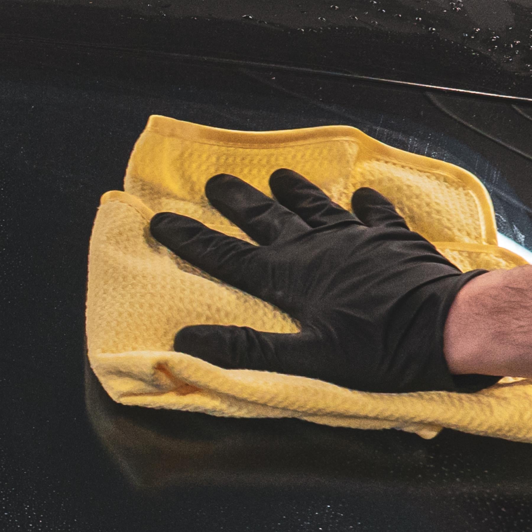 Microfibre cloth drying the top of a car