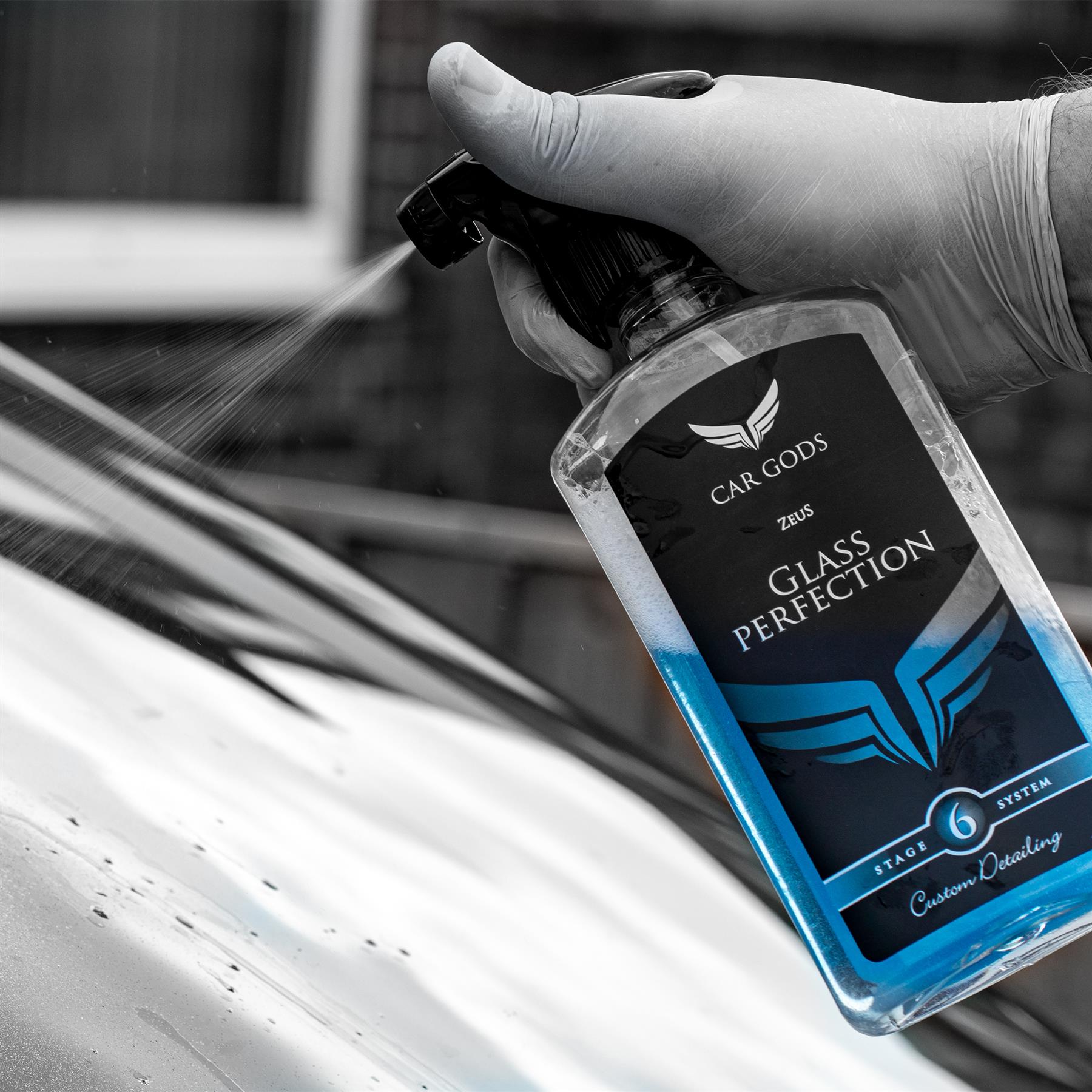 glass perfection being sprayed on a windshield