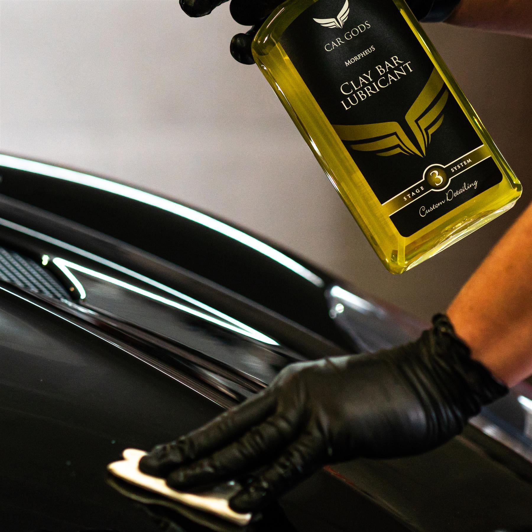 clay bar being applied onto Aston Martin Vanquish