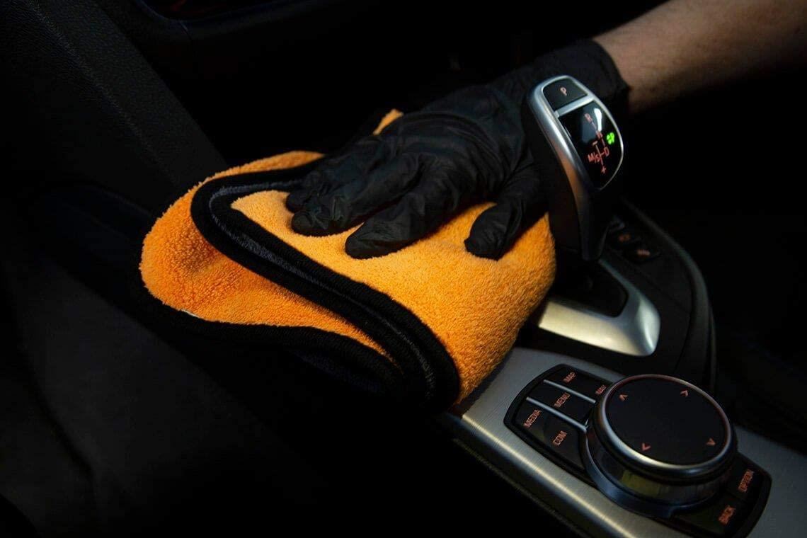 Wiping the interior of a BMW with a microfibre cloth