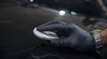 Applying clay bar to the bonnet of a car