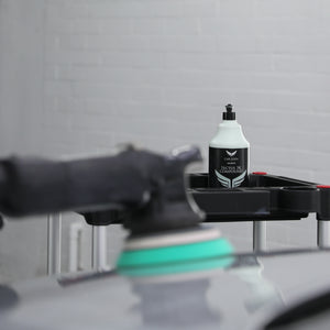 heavy cutting compound being applied to car paintwork with a machine polisher