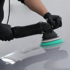 heavy cutting pad being used with a machine polisher on a car