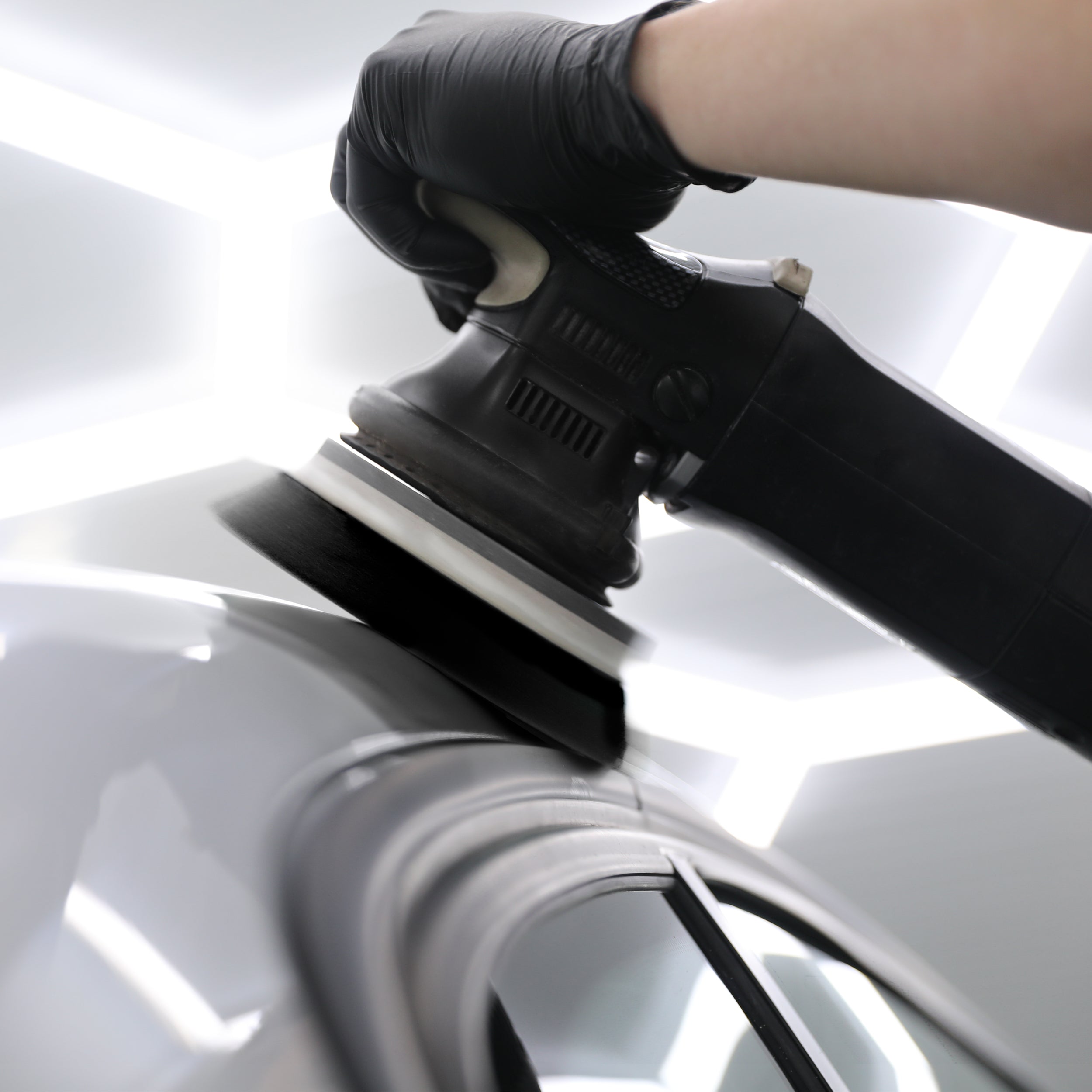 fine finish compound pad being used on a car