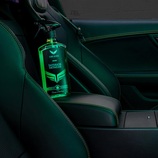 stylish shot of interior detailer bottle sat inside a leather seated car