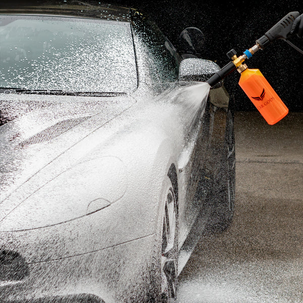 Snow foam shampoo in a cannon being sprayed onto a car