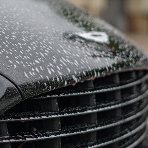 bug and sap remover sprayed onto the front of an Aston Martin Vanquish