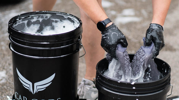 Rinsing a wash mitt in a detailing bucket