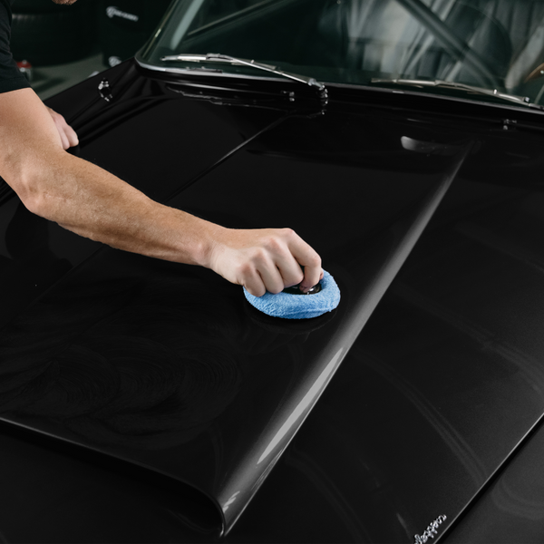 Applying black colour restorer onto Aston Martin DB5