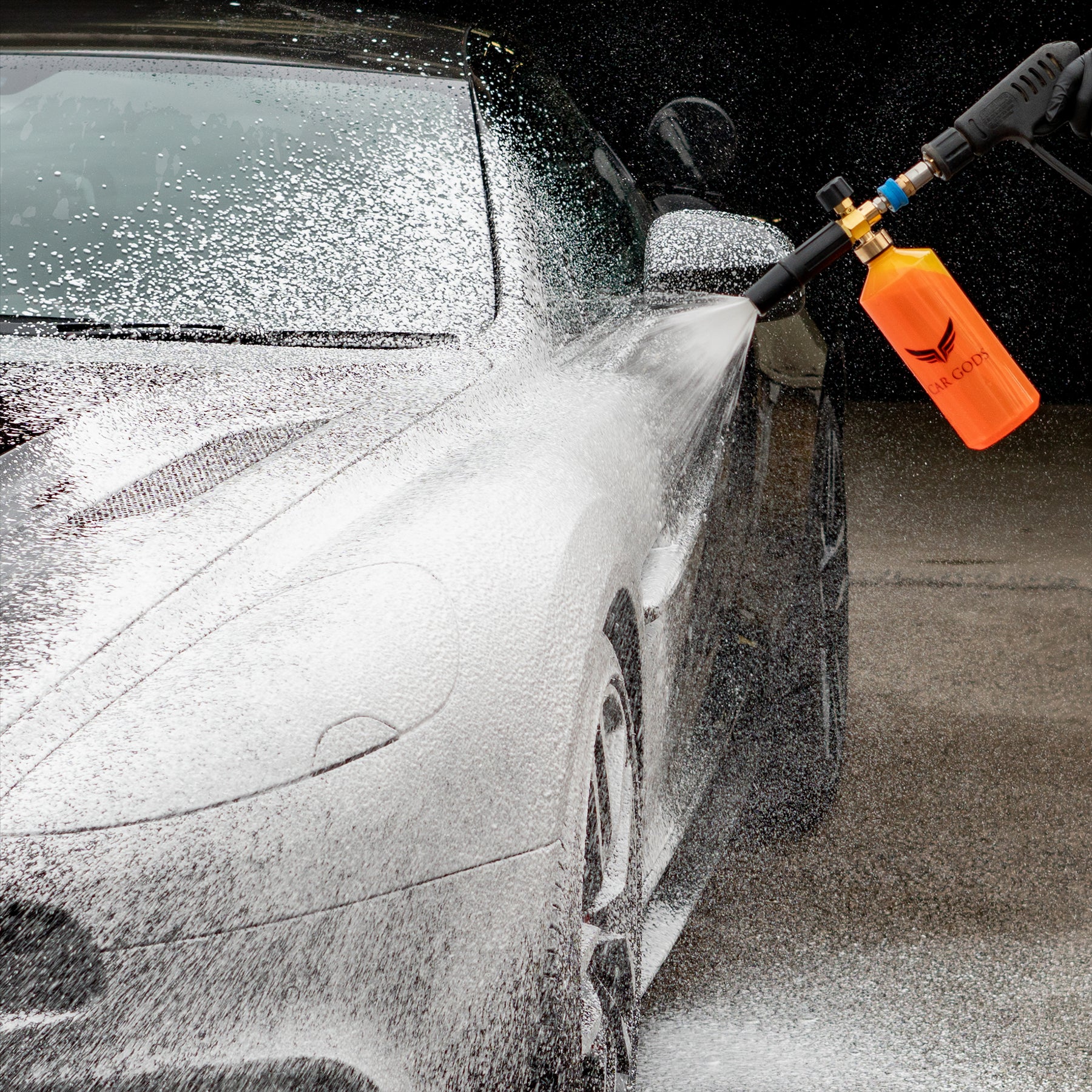 Snow foam in a cannon being sprayed at a car