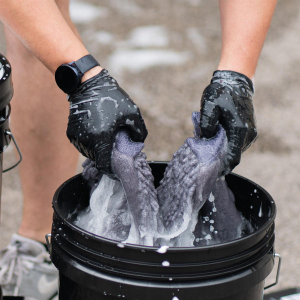 Rinsing a wash mitt in a detailing bucket