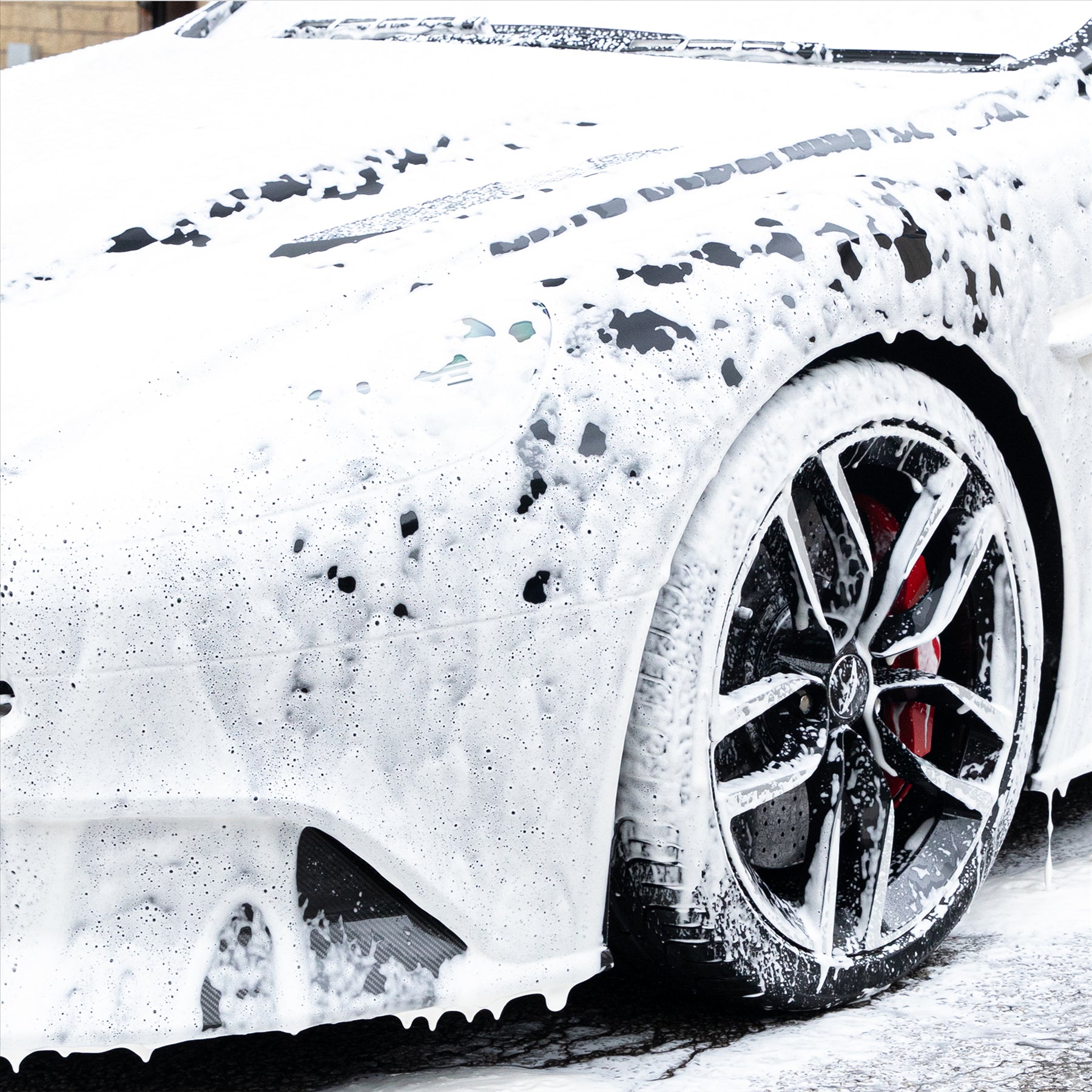 Car covered in a blanket of arctic storm snow foam